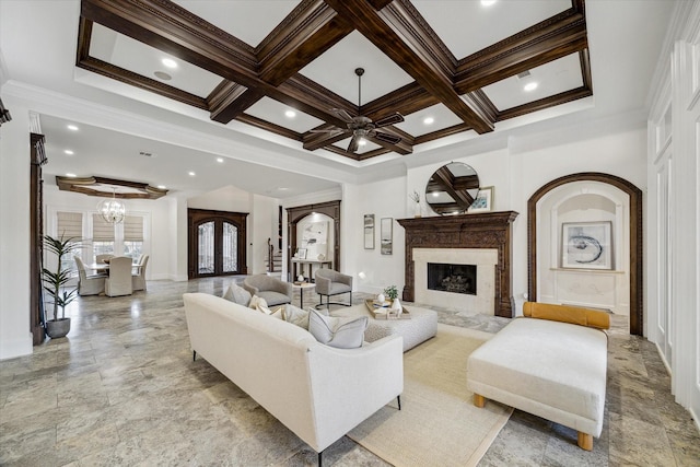 10 Broadwater Ct, Shenandoah, TX 77381 - living area featuring crown molding, a high end fireplace, a chandelier, ceiling fan, and coffered ceiling