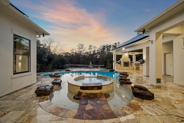 10 Broadwater Ct, Shenandoah, TX 77381 - pool at dusk with ceiling fan, a patio area, and a pool with connected hot tub