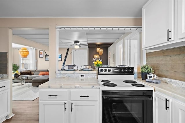 514 Texas, Surfside Beach, TX 77541 - kitchen featuring range with electric stovetop, a ceiling fan, light countertops, and white cabinets