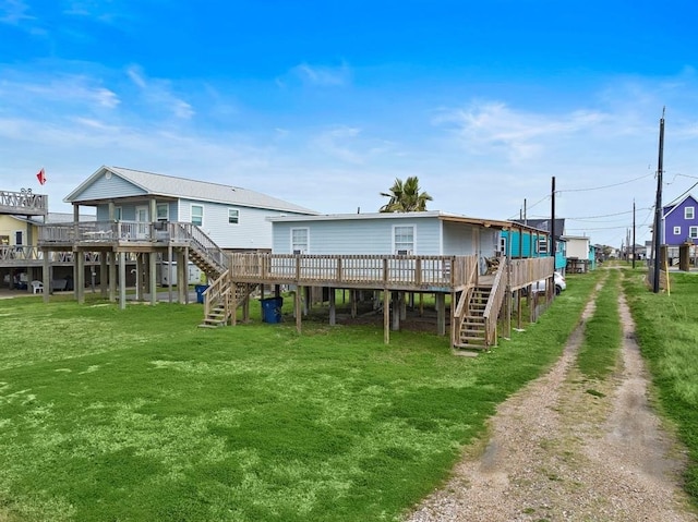 514 Texas, Surfside Beach, TX 77541 - rear view of house with stairway, a deck, driveway, and a yard