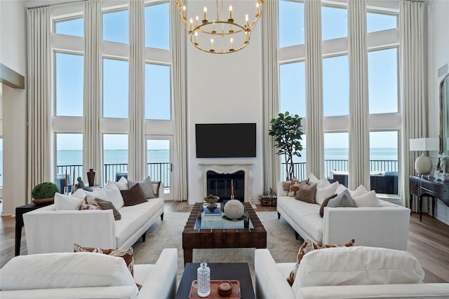 102 Lanai St, Tiki Island, TX 77554 - living room featuring a high ceiling, a chandelier, wood finished floors, and plenty of natural light