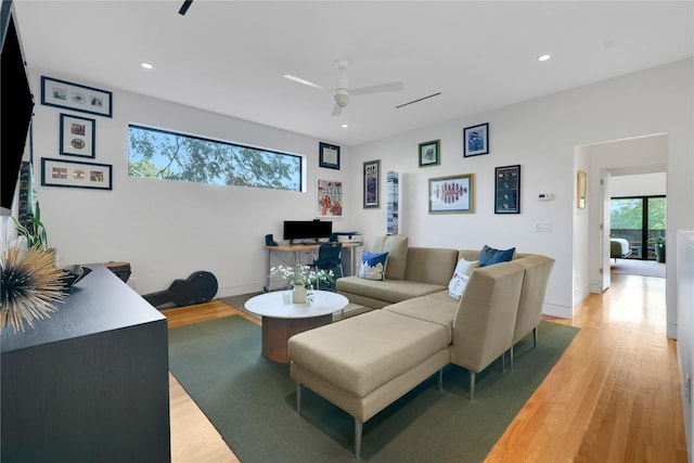 1136 Aurora St, Houston, TX 77009 - living area with light wood-type flooring, a ceiling fan, recessed lighting, baseboards, and a desk