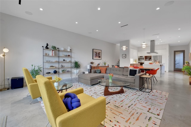 1136 Aurora St, Houston, TX 77009 - living room featuring finished concrete floors and recessed lighting