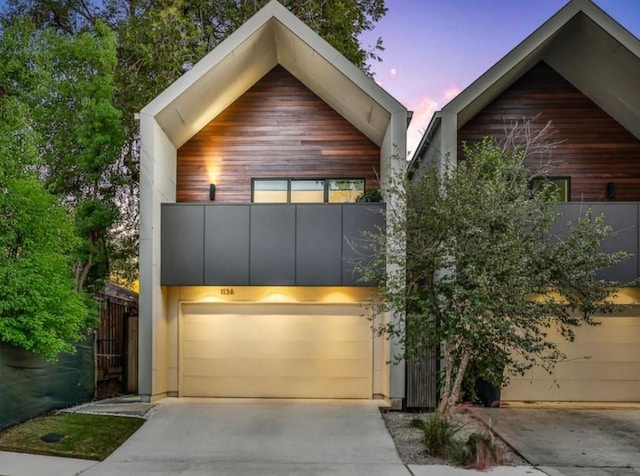 1136 Aurora St, Houston, TX 77009 - contemporary house featuring driveway, a garage, and a balcony