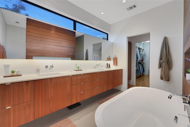 1136 Aurora St, Houston, TX 77009 - bathroom with double vanity, a soaking tub, a spacious closet, and recessed lighting