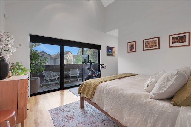 1136 Aurora St, Houston, TX 77009 - bedroom featuring access to exterior, light wood-style floors, and a towering ceiling