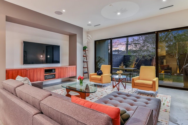 1136 Aurora St, Houston, TX 77009 - living room featuring finished concrete flooring and recessed lighting