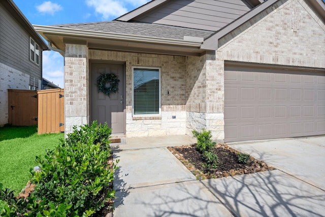 20010 Sienna Green Dr, Hockley, TX 77447 - doorway to property featuring a garage, roof with shingles, driveway, and brick siding