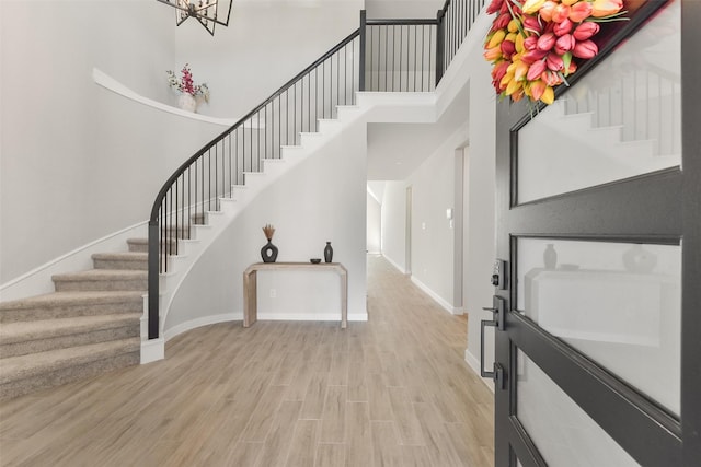 5107 Shimmering Brook Ln, Fulshear, TX 77441 - foyer with stairway, light wood-style floors, baseboards, a towering ceiling, and a chandelier