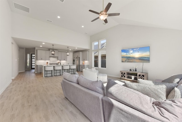 5107 Shimmering Brook Ln, Fulshear, TX 77441 - living room featuring high vaulted ceiling, ceiling fan, recessed lighting, light wood finished floors, and baseboards