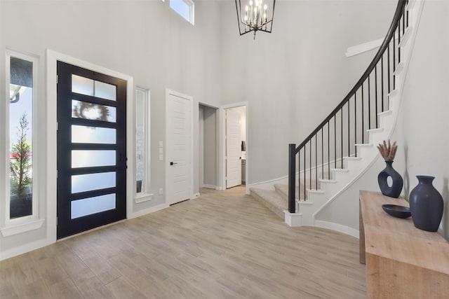 5107 Shimmering Brook Ln, Fulshear, TX 77441 - entryway with stairway, a chandelier, wood finished floors, baseboards, and a towering ceiling