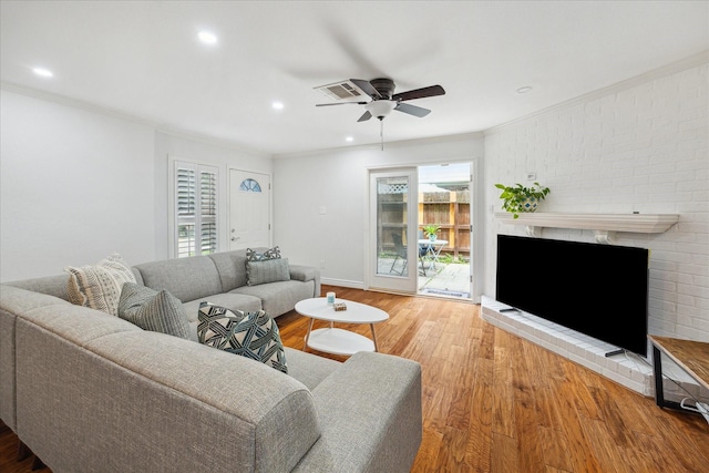 2513 Bering Dr Unit 13, Houston, TX 77057 - living room with ornamental molding, wood finished floors, ceiling fan, a brick fireplace, and recessed lighting