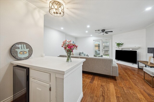 2513 Bering Dr Unit 13, Houston, TX 77057 - living room with wood finished floors, ornamental molding, recessed lighting, a ceiling fan, and a fireplace
