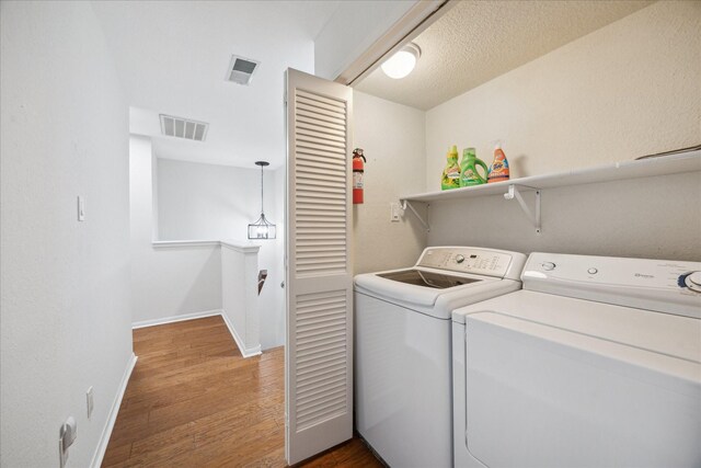 2513 Bering Dr Unit 13, Houston, TX 77057 - washroom with washer and dryer, wood finished floors, and baseboards