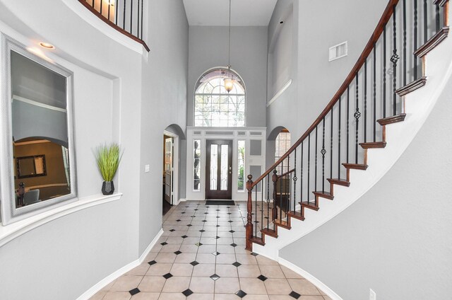 31 Hope Farm Rd, Missouri City, TX 77459 - tiled entryway featuring a high ceiling, baseboards, and stairs