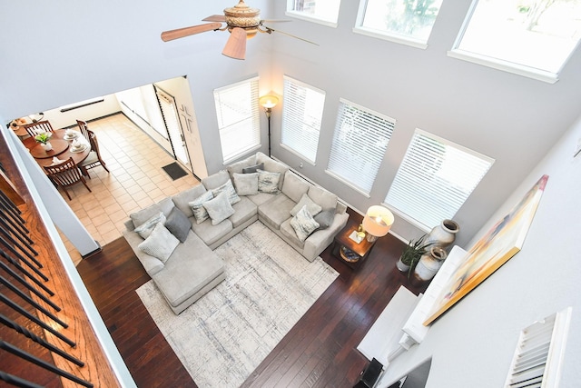 31 Hope Farm Rd, Missouri City, TX 77459 - living room featuring a high ceiling, ceiling fan, wood-type flooring, and stairway