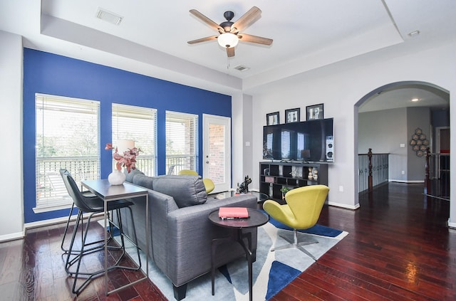 31 Hope Farm Rd, Missouri City, TX 77459 - living room with a raised ceiling, arched walkways, wood-type flooring, and a ceiling fan