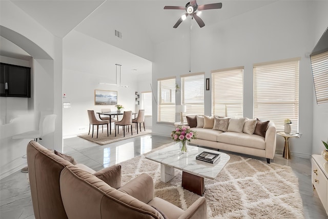 2019 Argos Dr, Missouri City, TX 77459 - living area with ceiling fan, arched walkways, high vaulted ceiling, and baseboards