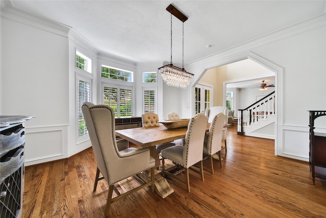 3 Pecan Trail Ln, Spring Valley Village, TX 77055 - dining space with crown molding, plenty of natural light, stairs, wood finished floors, and a decorative wall