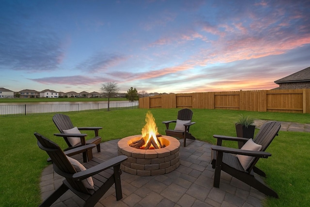 512 Maple Bnd, La Marque, TX 77568 - patio terrace at dusk with an outdoor fire pit, a patio, and a water view