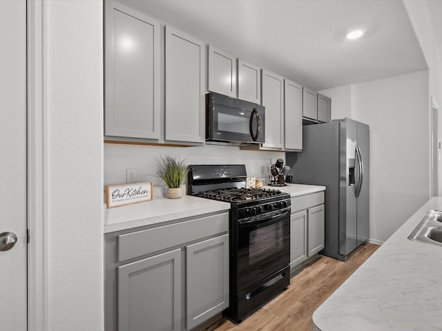 512 Maple Bnd, La Marque, TX 77568 - kitchen with black appliances, gray cabinets, and light countertops