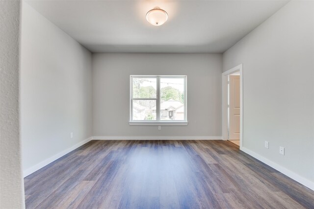 6615 Ezzard Charles Ln, Houston, TX 77091 - empty room featuring dark wood finished floors and baseboards