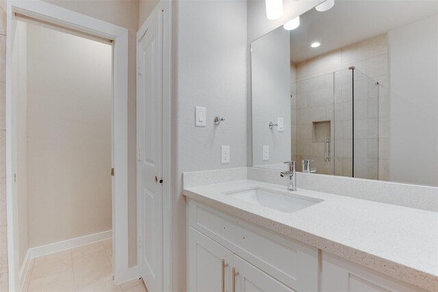 6615 Ezzard Charles Ln, Houston, TX 77091 - full bath featuring vanity, a shower stall, baseboards, and tile patterned floors