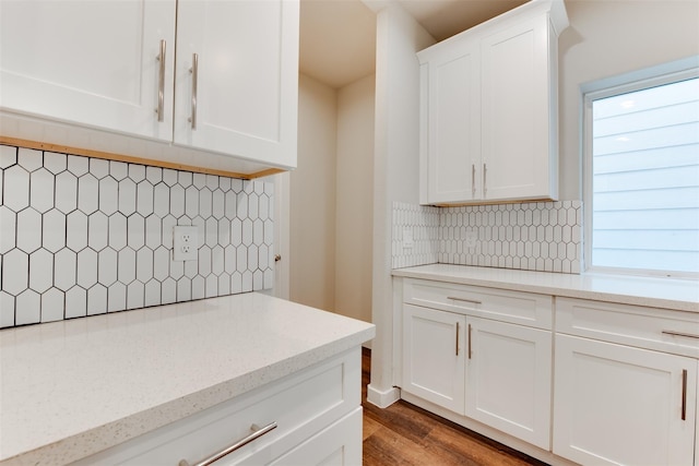 6615 Ezzard Charles Ln, Houston, TX 77091 - kitchen featuring backsplash, white cabinetry, wood finished floors, and light stone countertops