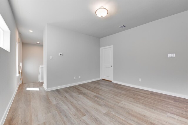 6615 Ezzard Charles Ln, Houston, TX 77091 - spare room with light wood-type flooring, recessed lighting, and baseboards