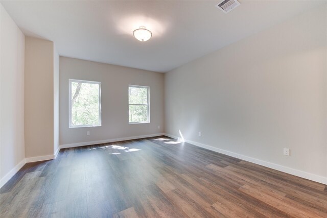 6615 Ezzard Charles Ln, Houston, TX 77091 - empty room with dark wood-style floors and baseboards