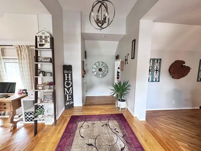 807 Trochta St, El Campo, TX 77437 - foyer entrance featuring a chandelier, baseboards, and wood finished floors