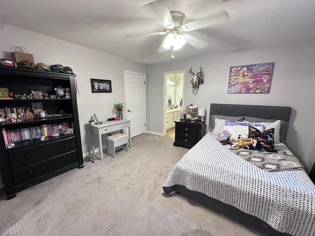 807 Trochta St, El Campo, TX 77437 - carpeted bedroom featuring ceiling fan, baseboards, and ensuite bath