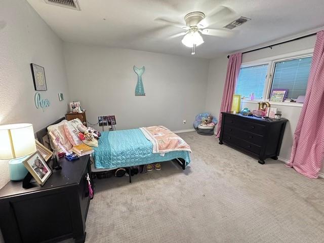 807 Trochta St, El Campo, TX 77437 - bedroom with carpet floors, ceiling fan, and baseboards