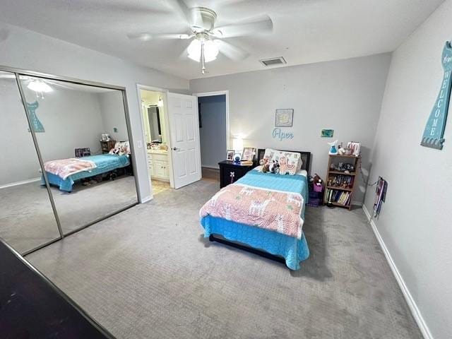 807 Trochta St, El Campo, TX 77437 - carpeted bedroom featuring baseboards, a closet, a ceiling fan, and ensuite bathroom