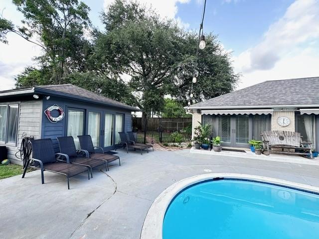 807 Trochta St, El Campo, TX 77437 - view of swimming pool with french doors and a patio