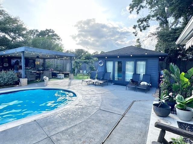 807 Trochta St, El Campo, TX 77437 - view of pool with a patio area, french doors, and an outdoor structure