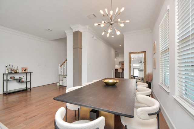 928 Dunbar St, Houston, TX 77009 - dining space featuring crown molding, a chandelier, wood finished floors, and stairway