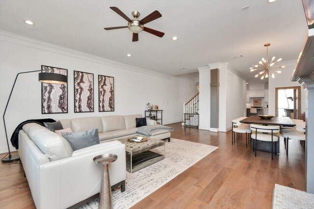 928 Dunbar St, Houston, TX 77009 - living room with crown molding, stairs, a ceiling fan, recessed lighting, and wood finished floors