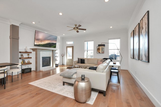 928 Dunbar St, Houston, TX 77009 - living room featuring ornamental molding, ceiling fan, recessed lighting, a tiled fireplace, and light wood-style floors