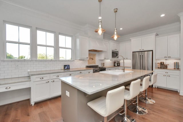928 Dunbar St, Houston, TX 77009 - kitchen featuring stainless steel appliances, a sink, ornamental molding, decorative backsplash, and white cabinetry