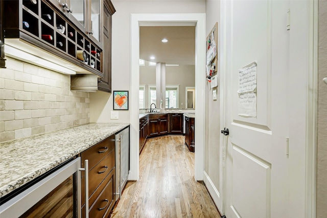 1418 Du Barry Ln, Houston, TX 77018 - kitchen with beverage cooler, light wood finished floors, tasteful backsplash, dark brown cabinetry, and light stone countertops