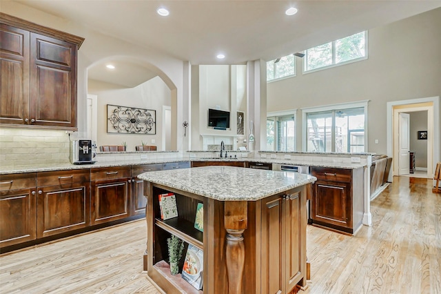 1418 Du Barry Ln, Houston, TX 77018 - kitchen with a kitchen island, tasteful backsplash, light wood-style floors, light stone countertops, and recessed lighting