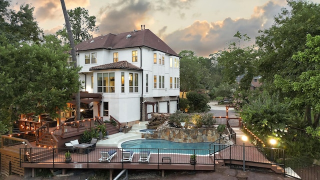 1 Magnolia Bend Dr, Hunters Creek Village, TX 77024 - back of house with a wooden deck, stucco siding, an in-ground hot tub, view of wooded area, and stairway