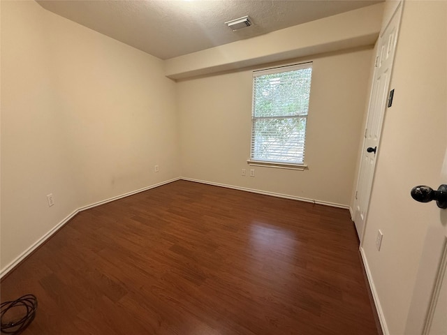 226 W Stedhill Loop, Conroe, TX 77384 - spare room featuring dark wood finished floors, baseboards, and a textured ceiling