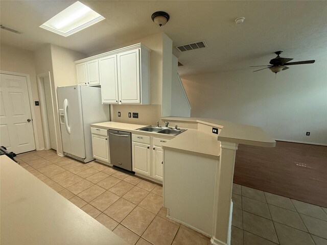226 W Stedhill Loop, Conroe, TX 77384 - kitchen with a peninsula, stainless steel dishwasher, white fridge with ice dispenser, a sink, and light tile patterned flooring