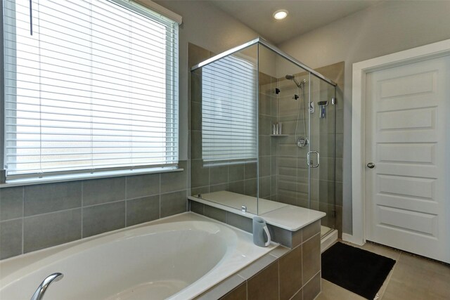 4910 Magnolia Springs Dr, Pearland, TX 77584 - bathroom with a bath, a stall shower, tile patterned flooring, and recessed lighting