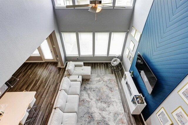 4910 Magnolia Springs Dr, Pearland, TX 77584 - living room featuring a high ceiling, a ceiling fan, and wood finished floors