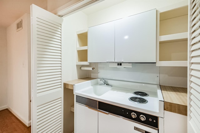 2322 Steel St Unit 19, Houston, TX 77098 - kitchen with open shelves, light countertops, white cabinets, a sink, and light wood finished floors