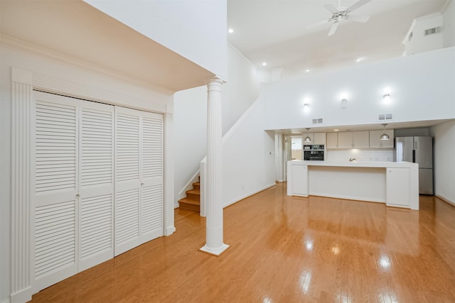 2322 Steel St Unit 19, Houston, TX 77098 - kitchen with freestanding refrigerator, black oven, light countertops, ceiling fan, and light wood finished floors