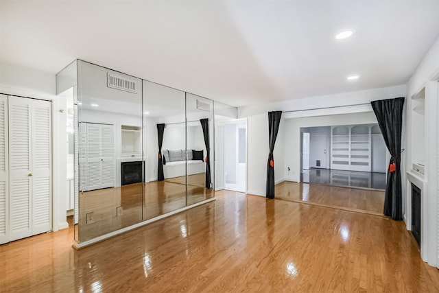 2322 Steel St Unit 19, Houston, TX 77098 - unfurnished bedroom featuring a fireplace, wood finished floors, recessed lighting, and baseboards